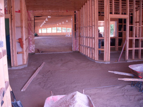The floors usually have a concrete floor that we lay our screed pipes on for our bedding layer. This layer we compact and pull once again to avoid any settling from the horses hooves.
